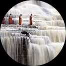 Monks standing on waterfall steps